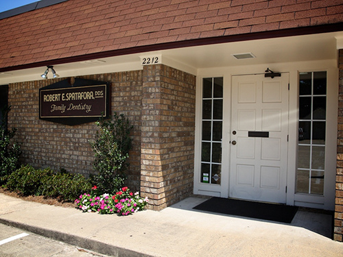 The image depicts a brick building with a sign that reads  Robert   Sons Family Law,  indicating it is a law firm.