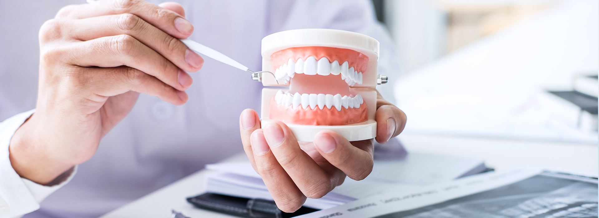 A person holding a toothbrush with toothpaste, examining it closely.