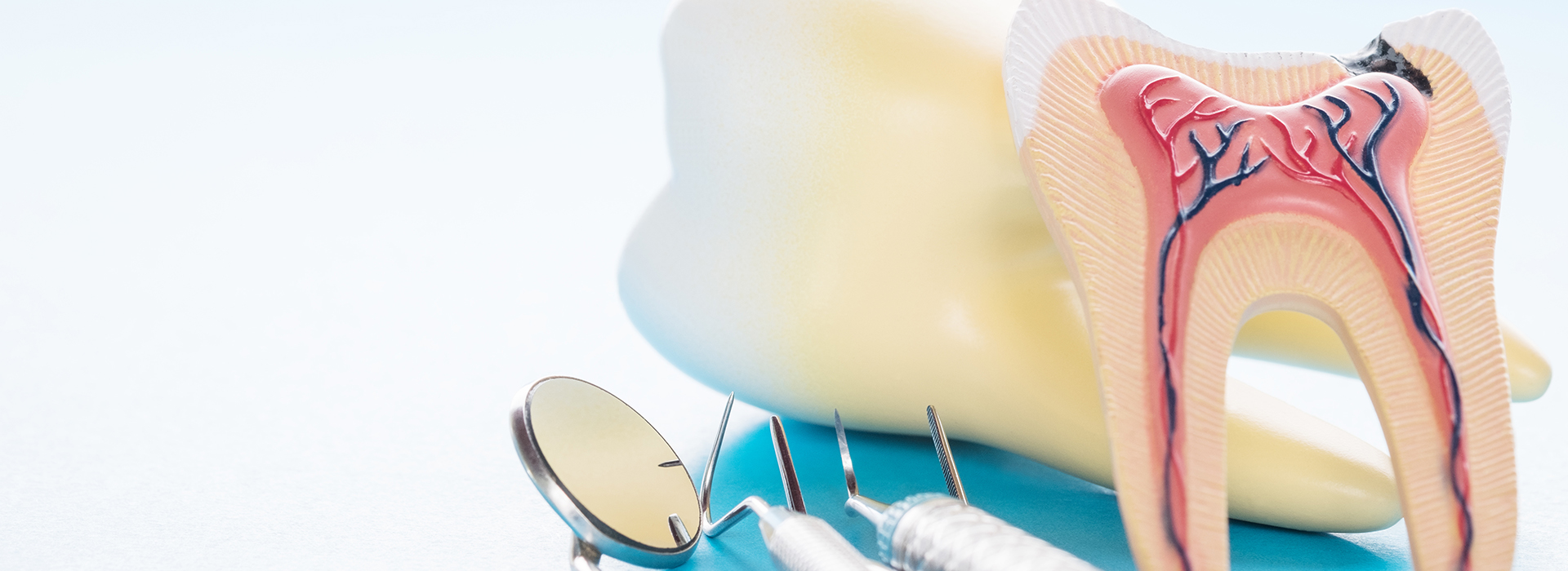 The image shows a toothbrush with bristles and a toothpaste tube, placed on a surface with a tooth model that has a cavity highlighted in red.